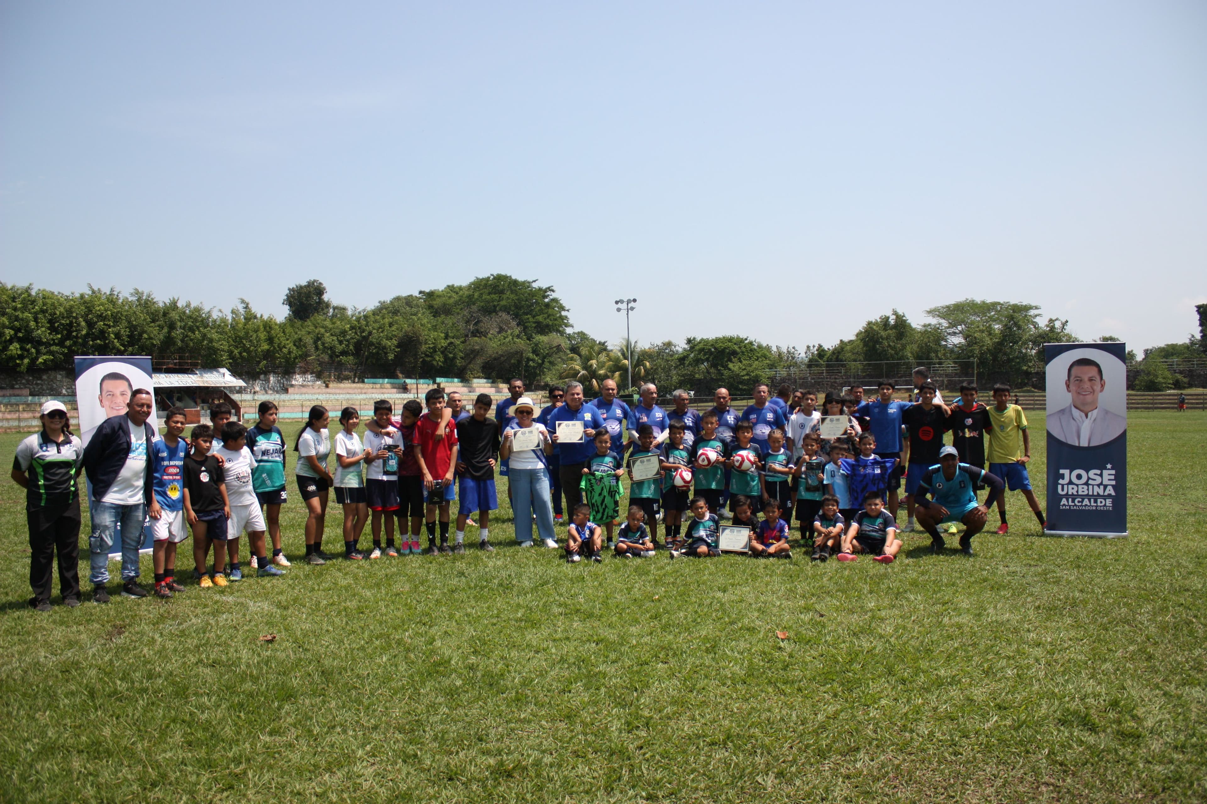 Photo of kids with soccer balls on the field
